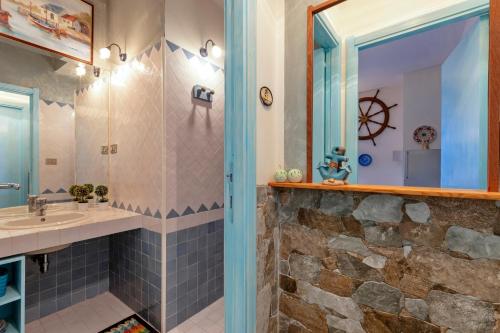 a bathroom with a sink and a mirror at Casa Erica in Stintino