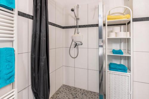 a shower with a glass door in a bathroom at Ferienwohnung am Bregenberg in Bräunlingen