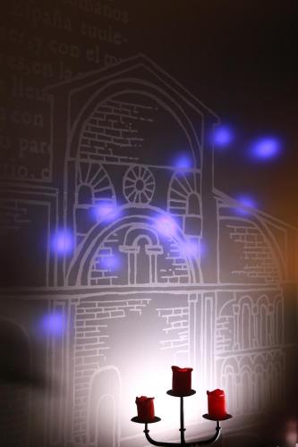 a room with blue lights and two tables with hats at Hospederia de Loarre in Loarre