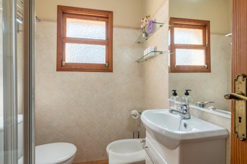 a bathroom with a sink and a toilet and a shower at Son Sant Joan in Alaró