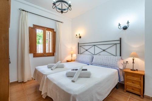 a bedroom with two beds and a window at Son Sant Joan in Alaró