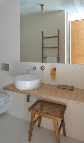 a bathroom with a sink and a mirror at Fisherman's Blues - Beach House in Arcozelo