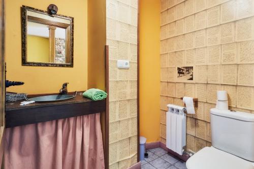 a bathroom with a sink and a toilet at La Casa De Anta in Asturianos