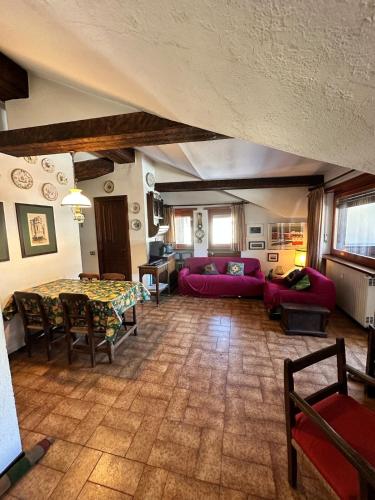 a living room with a table and a couch at Trilocale Einaudi Bardonecchia in Bardonecchia