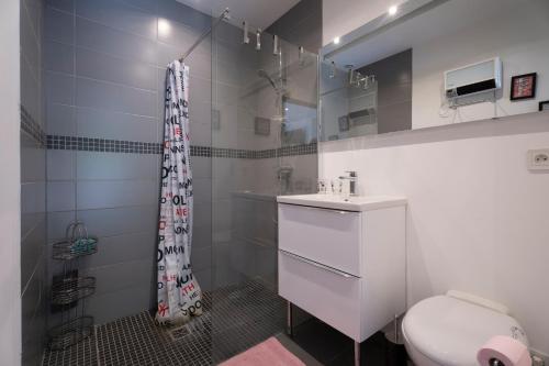 a white bathroom with a toilet and a sink at Studio moderne tout confort in La Valette-du-Var