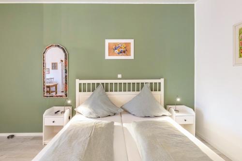 a bedroom with a large bed with two night stands at Garten Apartment in Kerken