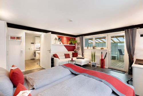 a large living room with a couch and a living room with at Apartment Am Tobelbach in Oberlenningen