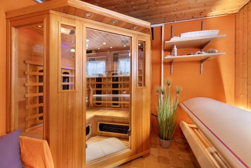 a wooden china cabinet in a room at Apartment Am Tobelbach in Oberlenningen