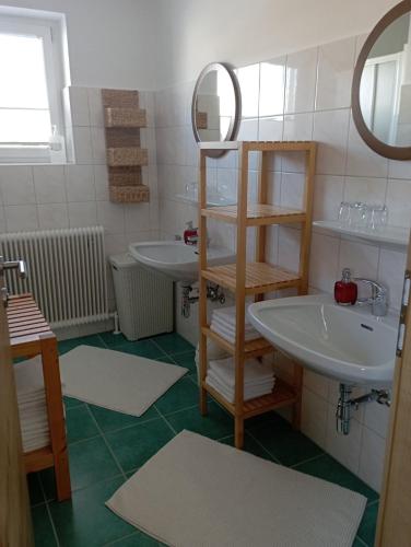 a bathroom with two sinks and a mirror at Ferienwohnung Lienbacher in Abtenau