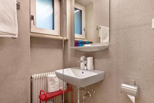a bathroom with a sink and two mirrors and a radiator at Alter Fausthof in Fie allo Sciliar