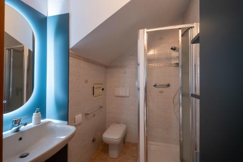 a bathroom with a toilet and a sink and a shower at I Love Baia Verde spa in Baia Verde
