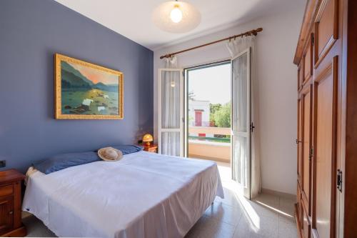 a bedroom with a bed and a large window at I Love Baia Verde spa in Baia Verde