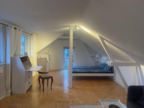a bedroom with a bed and a staircase in a attic at Oberneulander Gästehaus in Bremen