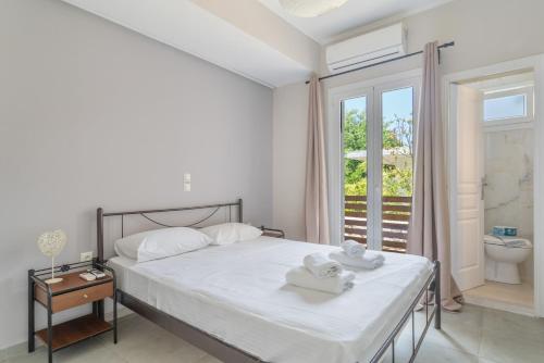a bedroom with a bed with towels on it at Stathis Home in Exanthia