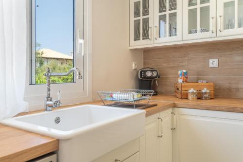 a kitchen with a sink and a window at Stathis Home in Exanthia