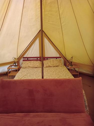 a bed inside of a tent with two beds at Glamping C Selva Tenda Quercia in Piano Porlezza