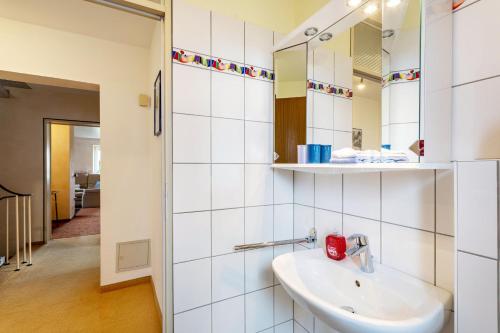 a bathroom with a sink and a mirror at Haus Waldblick in Bad Berleburg