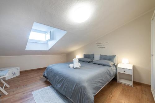a bedroom with a large bed and a skylight at Al Chiaro di Luna in Decimomannu
