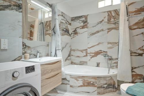 a bathroom with a sink and a washing machine at Elia home kanali in Kanali