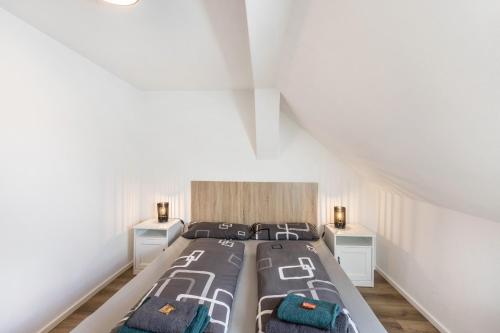 a bedroom with a bed with two night stands at Eichendorff Loft in Nordhausen