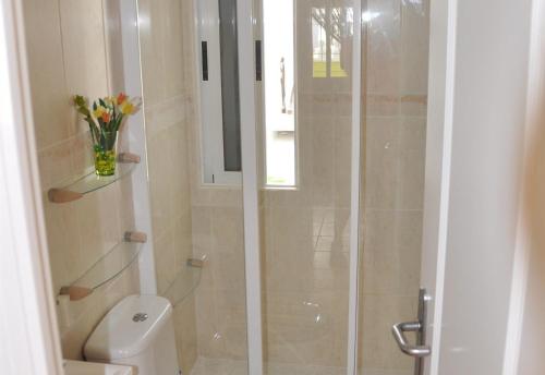 a bathroom with a shower with a toilet and a sink at Villa with private pool - near golf in San Miguel de Salinas