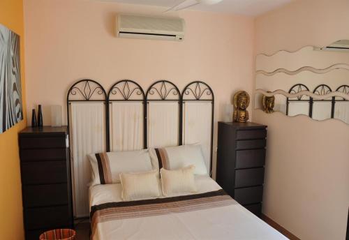 a bedroom with a large bed with white pillows at Villa with private pool - near golf in San Miguel de Salinas
