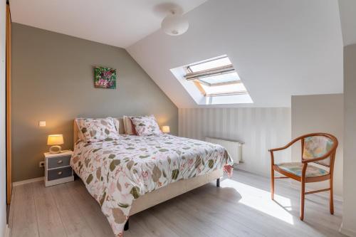 a bedroom with a bed and a chair at Ty Gwen in Ploeren