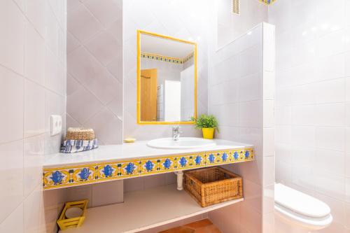 a bathroom with a sink and a mirror at Beachfront Apartment Port de Soller in Sóller