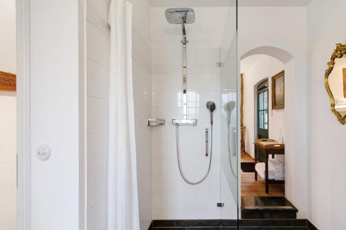 a shower with a glass door in a bathroom at Gut Rattelvitz - Parterre Ost in Gingst