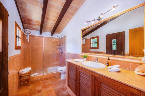 a bathroom with a sink and a shower and a toilet at Can Seguinot D'alt in Pollença