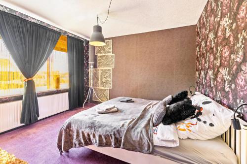 a bedroom with a bed with a teddy bear laying on it at Das Atelier in Ihlow