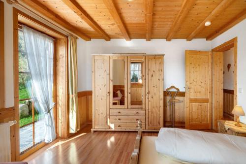 a bedroom with a bed and a large window at Krährbauernhof mit Hofladen in Hornberg