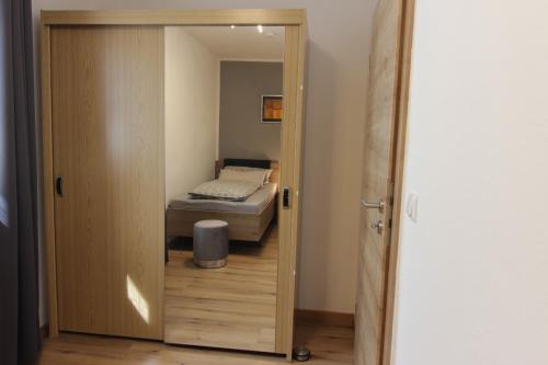 a door leading to a bedroom with a bed at Ferienwohnung Oberpfälzer Wald in Vohenstrauß
