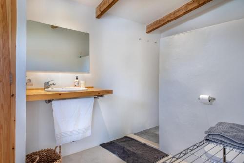 a bathroom with a sink and a mirror at Finca Laurel in Islas Baleares