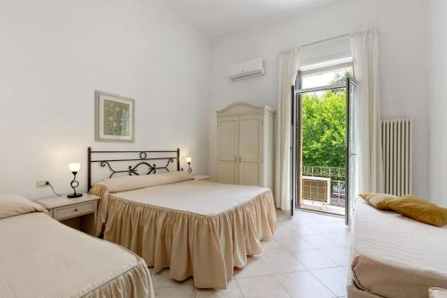 a bedroom with two beds and a window at Affittacamere Borgo Trento in Verona