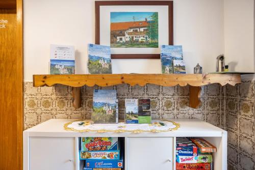 a shelf on top of a refrigerator with books on it at Beim Blitz ehemals Haus Maier in Schwangau