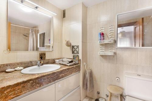 a bathroom with a sink and a mirror at Playa Graciosa in Arona
