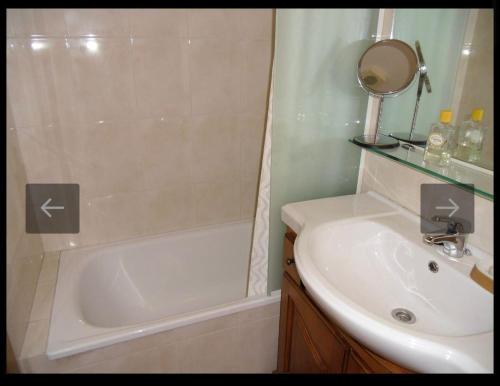 a bathroom with a tub and a sink and a mirror at El Mirador de Llanars in Llanars