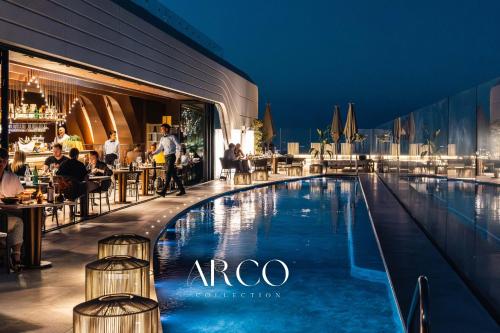 a swimming pool in front of a restaurant at Luxury Little Gem Mercury Tower w Rooftop Pool By Arco Collection in St. Julianʼs