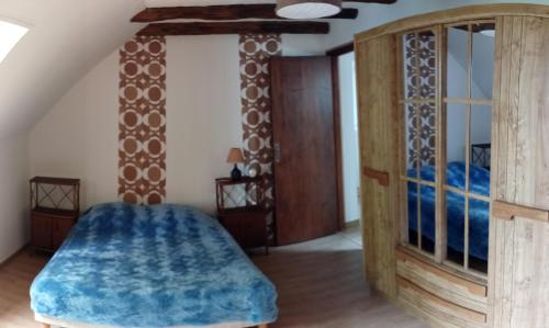 a bedroom with a bed and a wooden cabinet at Aux souvenirs d'Antan in Broyes