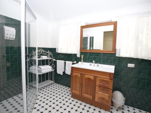 a bathroom with a sink and a shower with a mirror at The Provincial in Minlaton