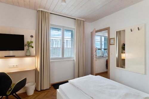 a hotel room with a bed and a television at Pension Waldliesel in Dornstetten