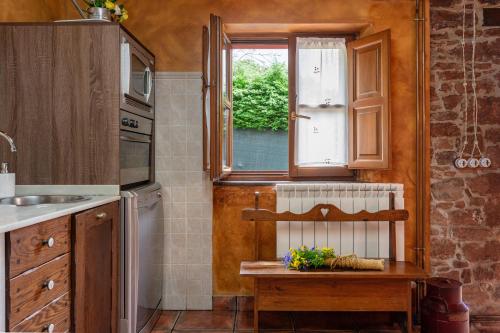 a kitchen with a window and a wooden table at Lolo in Villaviciosa