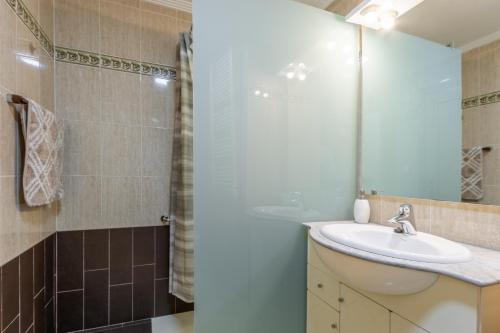 a bathroom with a sink and a shower at Isabela in Calpe