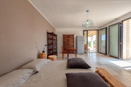 a bedroom with a large bed with pillows on it at La casa di Rollo in Otranto