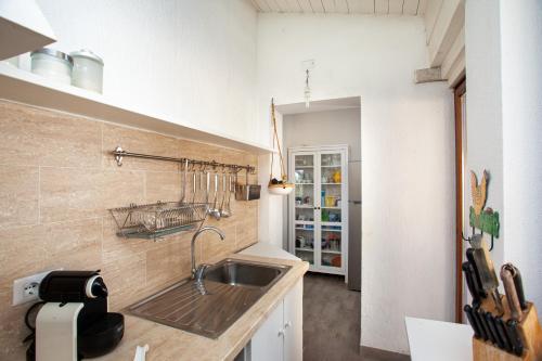 a kitchen with a sink and a counter at Risveglio con alba in San Teodoro