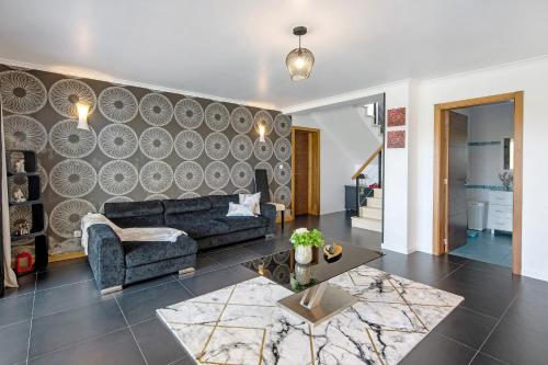a living room with a couch and a table at Casa da Orquidea in Ribeira Grande