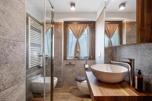 a bathroom with a tub and a sink and a toilet at Torre St Orso 4061 Maison Gerard in Cogne