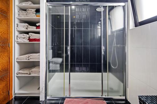 a glass shower in a walk in closet at Casa da Orquidea in Ribeira Grande