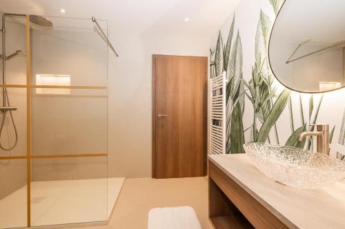 a bathroom with a sink and a mirror at Appartements N°37 in Hüttschlag